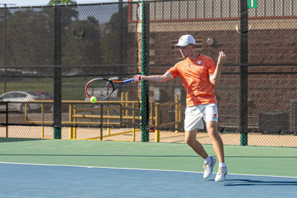 Senior Adam McCarter swings his racket in home match against Pine Tree Tuesday, Sept. 26, 2023. The Tigers defeated the Pirates with a score of 22-0.