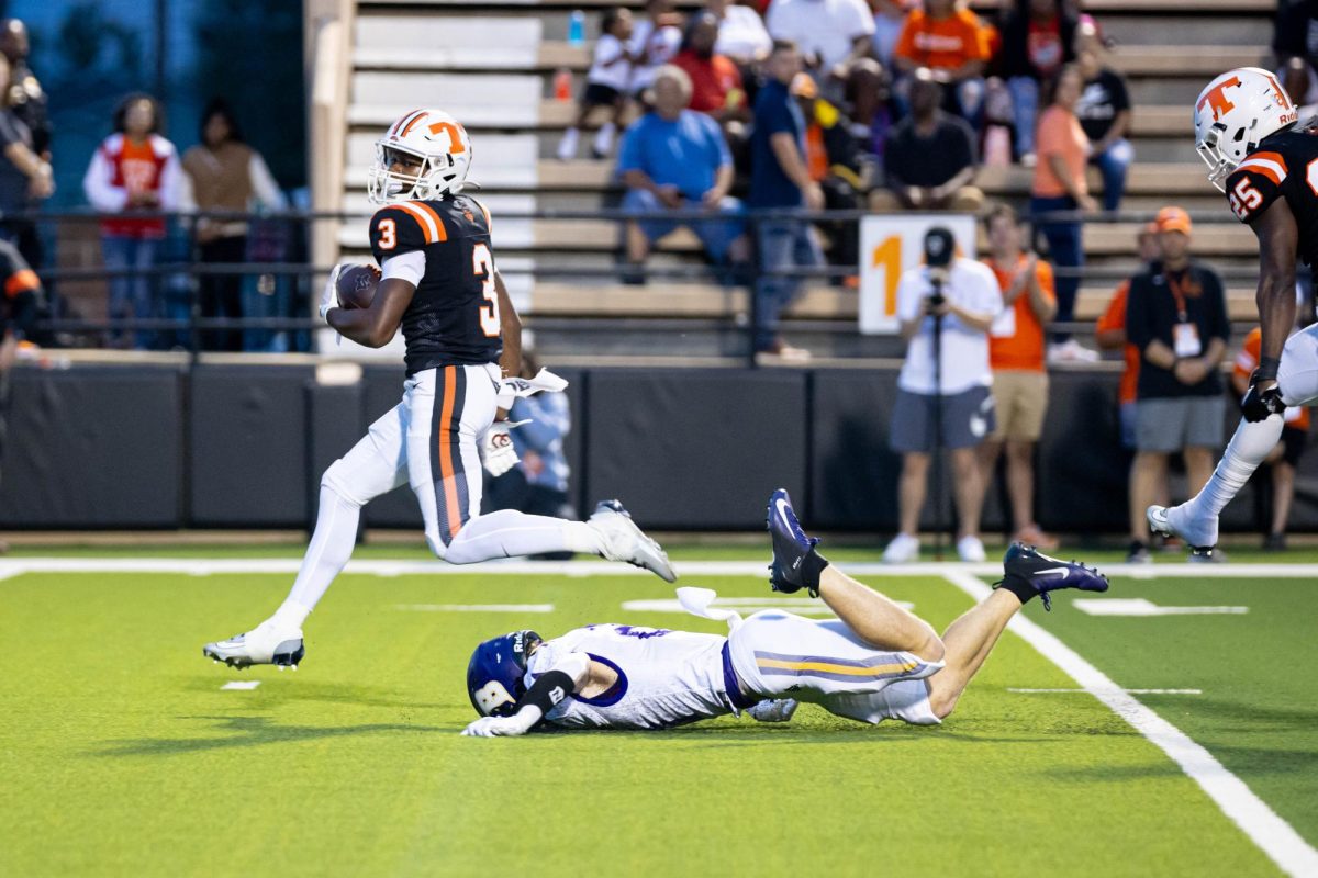 Leaping over the Benton defense, Sophomore running back, Tradarian Ball sprints for the end zone. The Texas Tigers smushed the Benton Tigers with a score of 62-14.