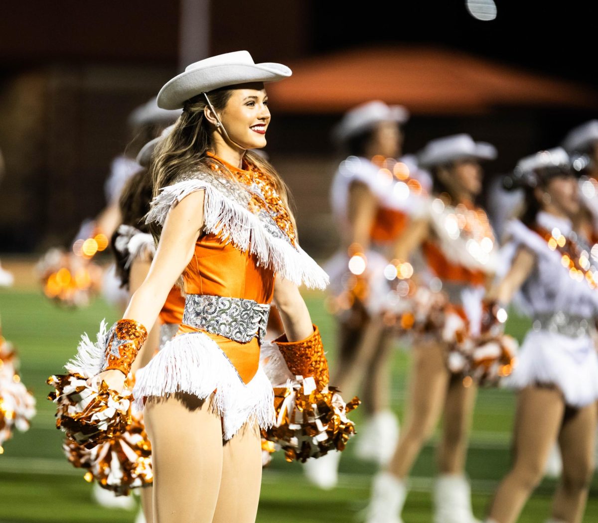 Senior HighStepper Kennedi McHenry smiles during the Texas halftime performance Friday, Sept. 8, 2023. The HighSteppers performed a pom routine for their halftime showing. 