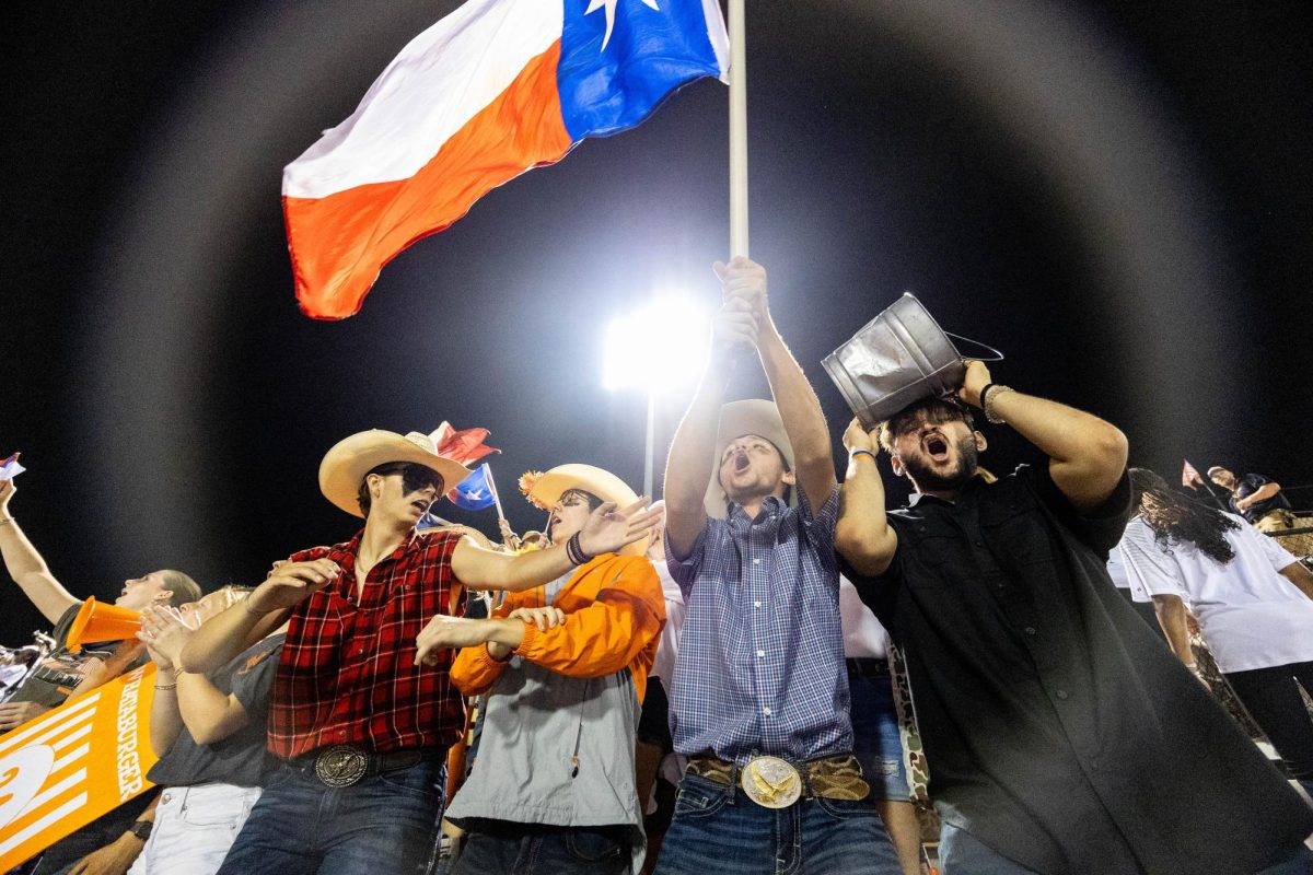 Senior student section leader Will Pruitt Waves the Texas flag in a pre-season game against the Benton Tigers Friday, Sept. 8, 2023. The Texas High student section had a theme of Texas for the game.
