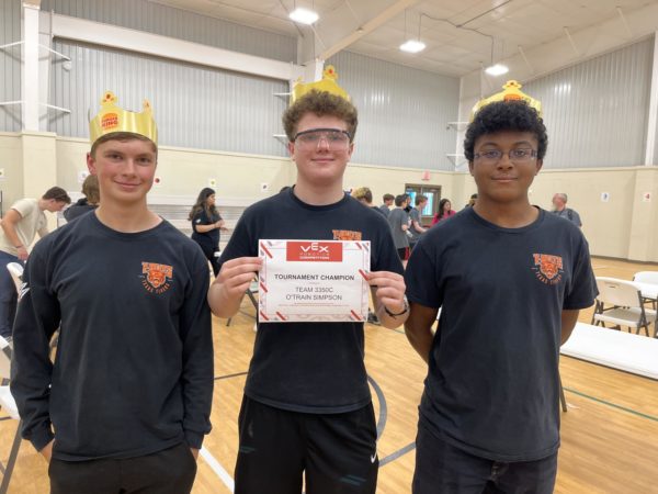 Standing next to his teammates, Senior Nicholas Spivey holds a certificate at a robotics competition. Texas Highs robotics team has been preparing for the upcoming season.
