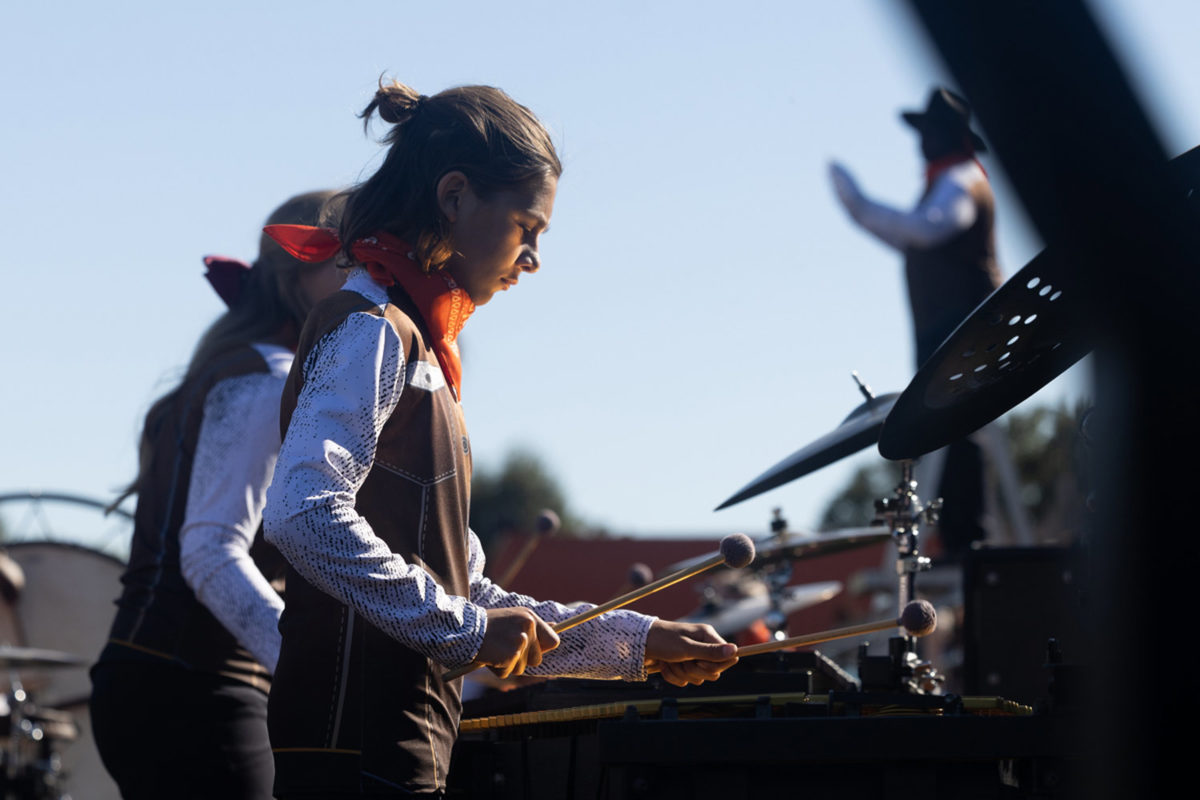 Head+down%2C+freshman+Jackson+Carter+focusing+while+he+holds+his+mallets+to+play+the+vibraphone.+The+Tiger+Band+competed+in+the+Four+States+Marching+Contest+on+Oct.+7%2C+2023.