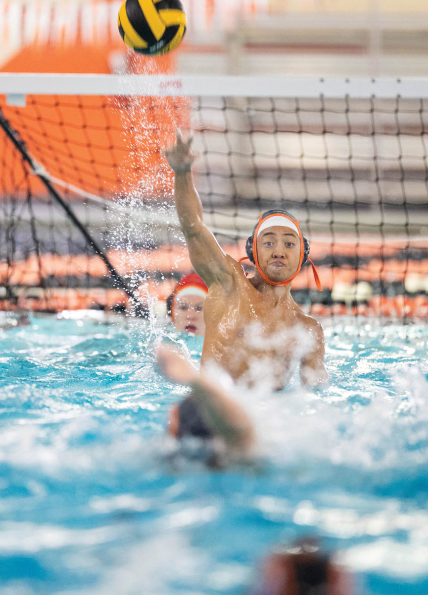Senior Nash Orena makes a pass to an offensive player in their game against Forney. Orena and other seniors provide leadership in the second year of waterpolo at Texas High School.