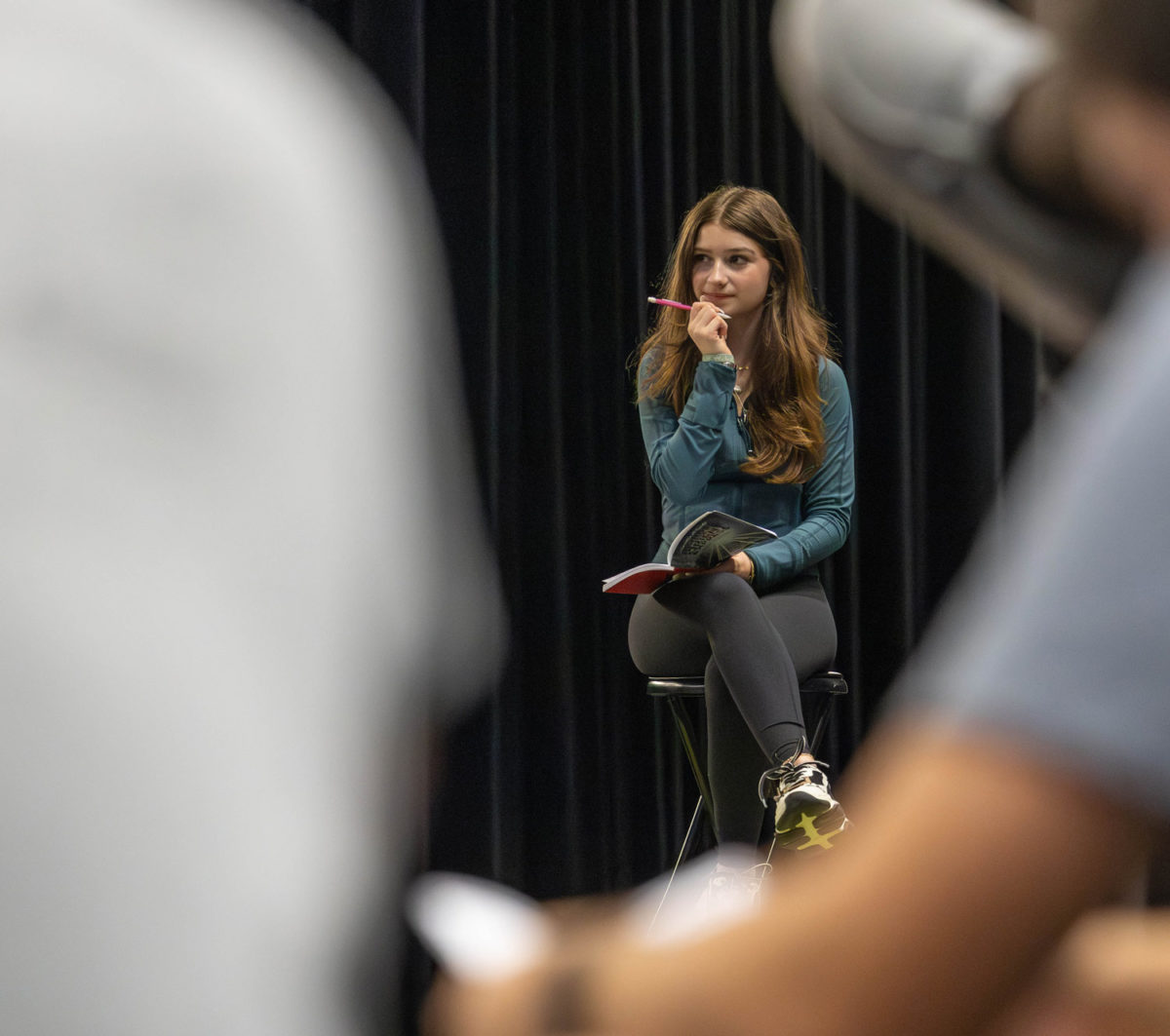 Glancing to the side, Senior Riley White participates in theater practice in preparation for their show, Murder on the Orient Express on Aug. 29, 2023. White has been a member of the Tiger Theatre story for six years.