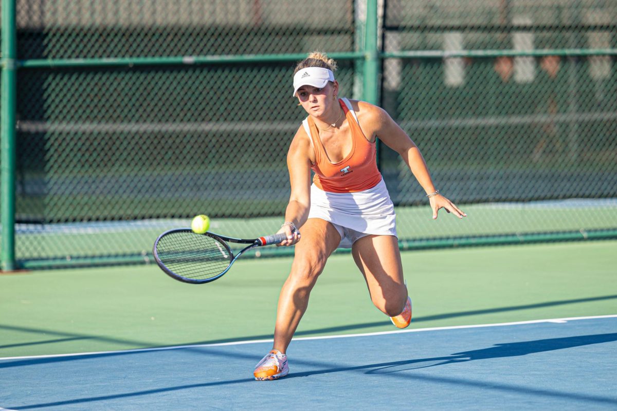 Senior Grace Wilson returns the ball with a forehand swing in a district match against Pine Tree Tuesday, Sept. 26, 2023. The Tigers finished second overall in district and lost in the Area round of playoffs.