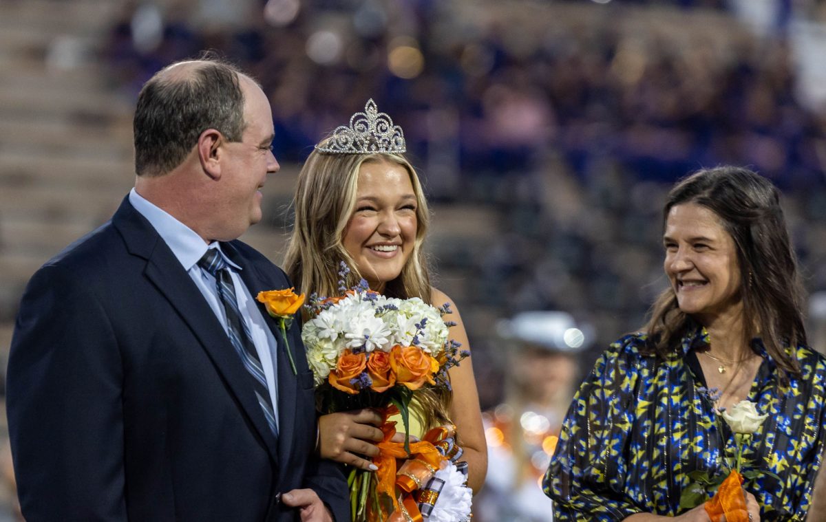 Senior Nealy Anderson smiles with joy with her parents after being crowned 2023 Homecoming Queen Friday, Sept. 29, 2023. The Homecing Court boasted nine girls selected by the student body.