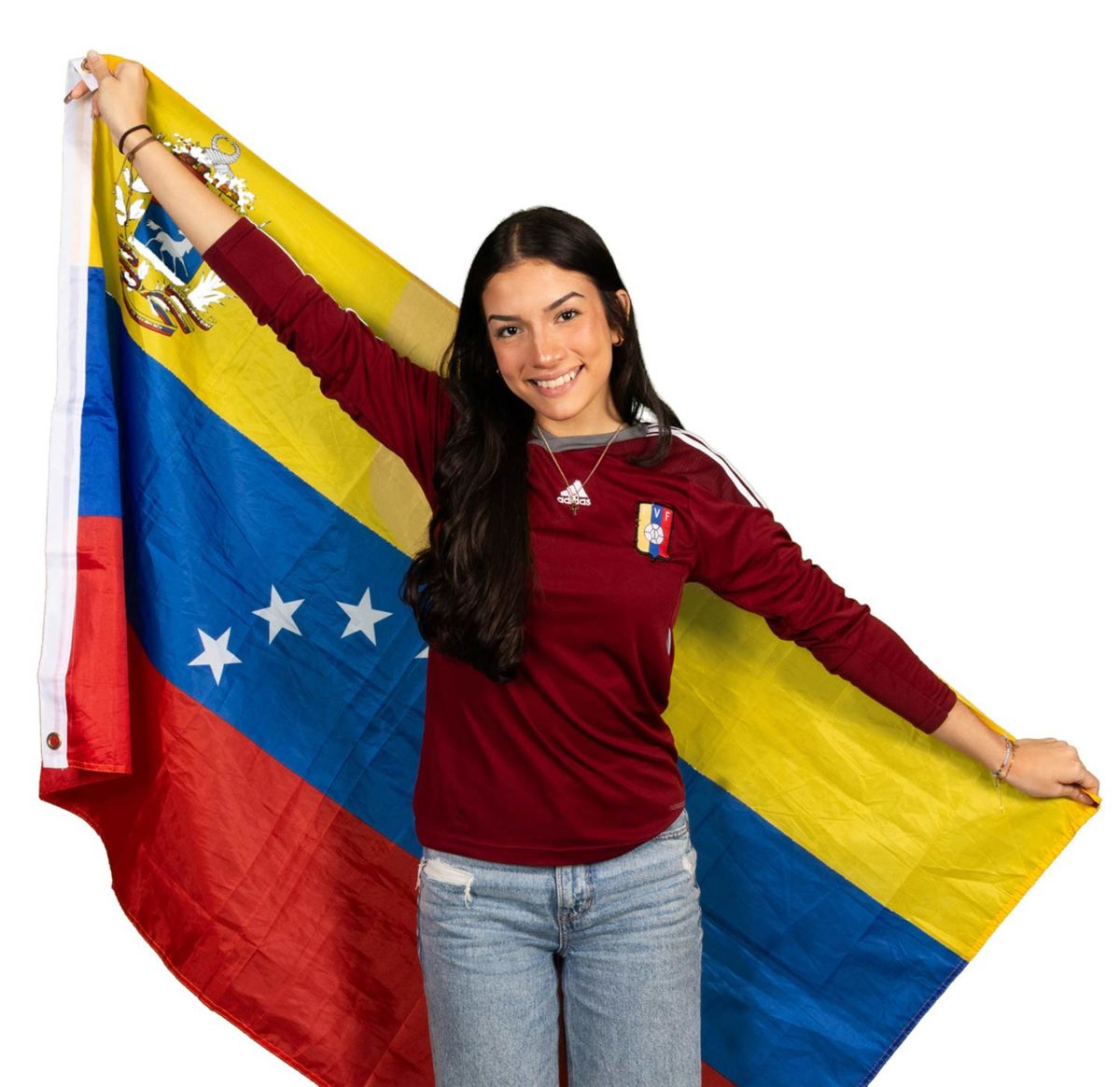 Arms+spread%2C+Senior+Isabel+Silva+holds+a+Venezuelan+flag+representing+her+home+country.+Silva+moved+to+the+United+States+in+2018.