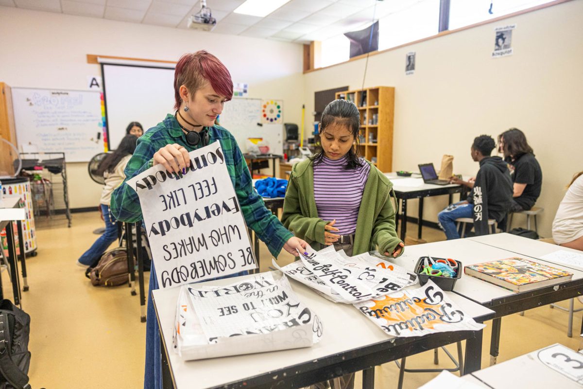 Art Club students hold signs they made for the bathrooms. Leader In Me and Art Club paired to add positive messages throughout the bathrooms.