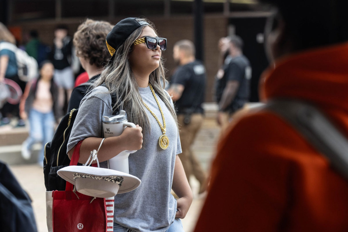 Freshman Aryana Starnes walks into school during arrival dressed as a rapper. Texas High School students and staff participated in the Rapper vs. Rockstar Spirit Day on Sep. 25, 2023. 