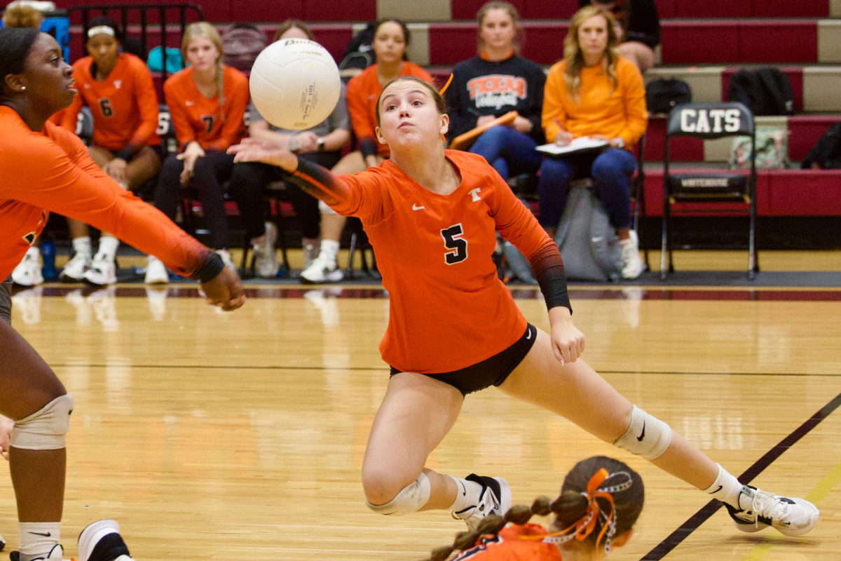 Senior Mally Lumpkin dives for a ball during a rally during the volleyball match against Whitehouse on Oct. 3, 2023. The Tigers traveled to Whitehouse and lost.