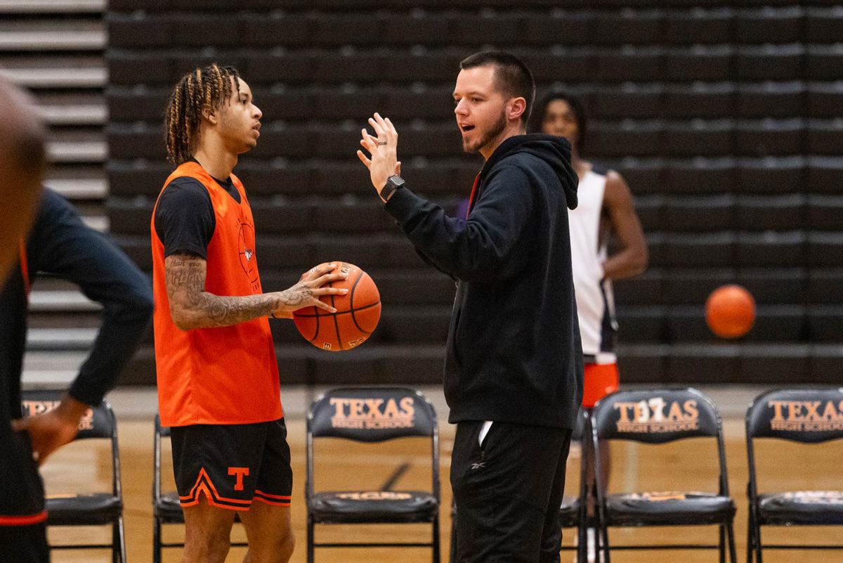 New head basketball coach, Eric Cross, coaches senior Vonderrick Perkins during practice on Nov. 14, 2023. Cross took over the basketball program starting in the 2023-2024 school year. 