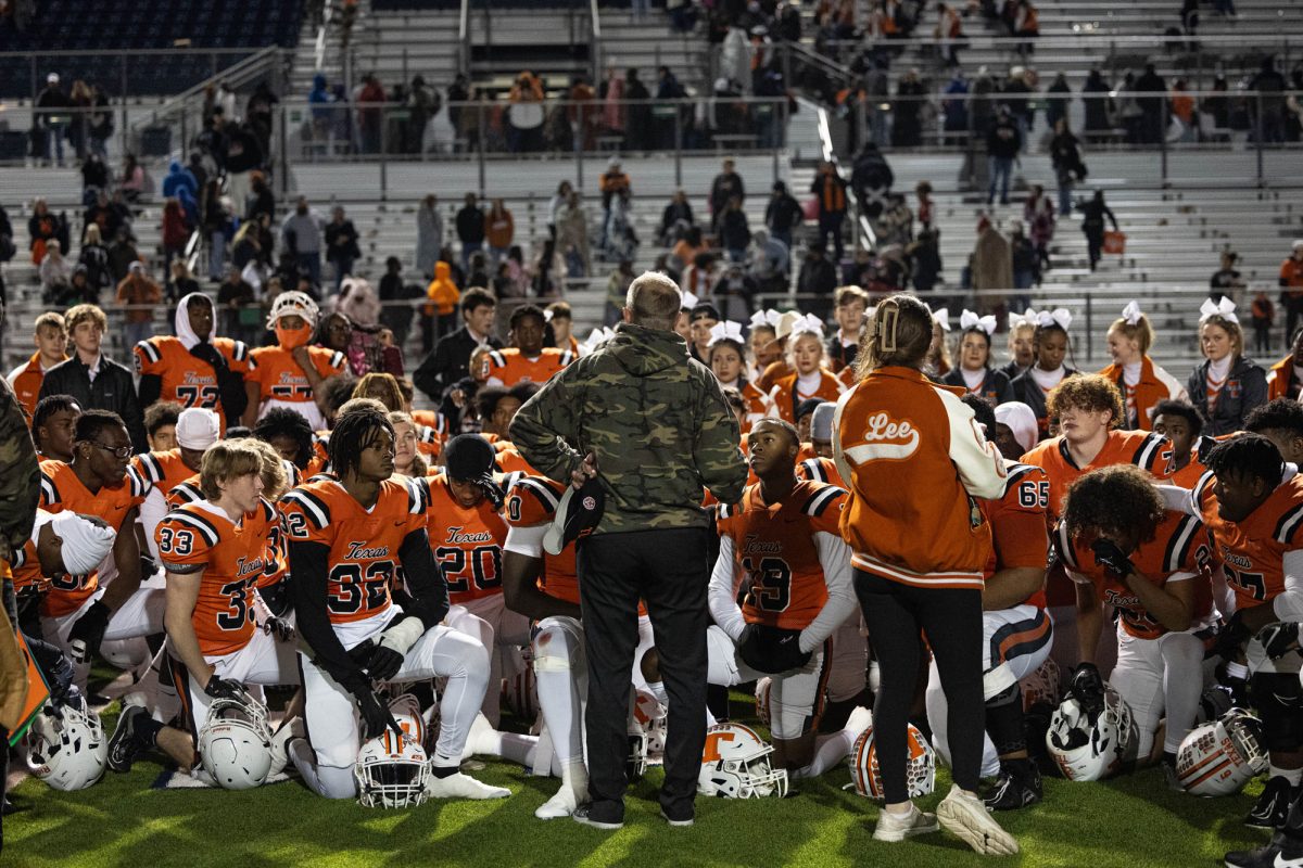 After losing out of the third round of playoffs, the varsity football team and the varsity cheer team gather around Athletic Director Gerry Stanford for a prayer. The Texas Tigers lost to the Lucas Lovejoy Leopards with a score of 43-21.