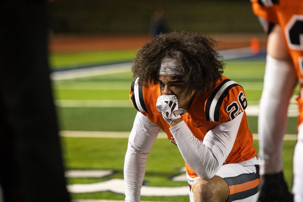 Senior Trystan Powell takes a knee at the conclusion of his final game as a Texas Tiger Friday, Nov. 24 2023. The Tigers took the loss with a final score of 21-43.
