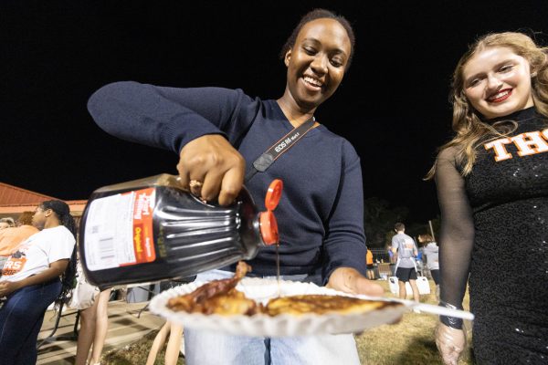 Senior Truth Dukes pours syrup on her pancakes during Texas High Schools annual Bacon fry at Tiger Stadium on Nov. 7, 2023. The bacon fry has been a tradition for years in preparation of the Texas vs Arkansas game. However, the game has not been played since the 2019 football season. Texas High continues the tradition regardless of if the game takes place or not. 