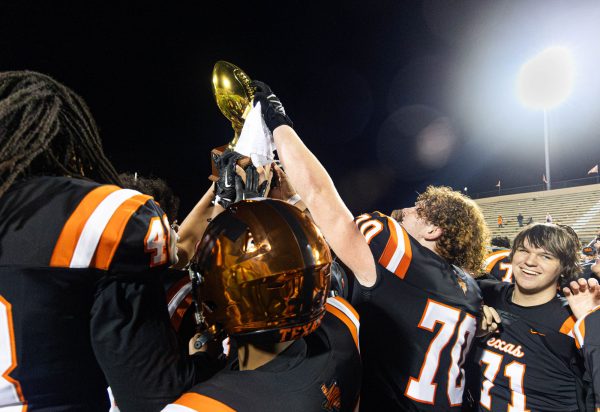 The Texas High Varsity football team holds the Bi-Distict Championship trophy after defeating the Terrell Tigers on Nov. 10, 2023. The Tigers face Mansfield Summit in Sulphur Springs, Texas on Friday, Nov. 17, 2023