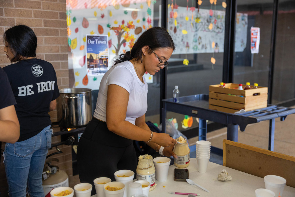 Junior Lexi Lucky prepares the elote for the Multicultural club fundraiser. Unlike previous years, the club is unable to sell their popular aguas fresas and fresas con crema due to the nutritional restrictions.