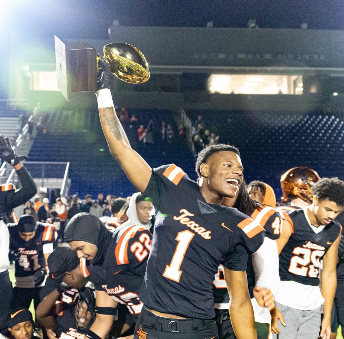 Senior wide receiver TJ Gray cheers triumphantly after the Texas High Tigers scratched off a victory against the Mansfield Summit Jaguars. The Tigers beat the Jaguars 17-14 and advanced to round three of the playoffs. 