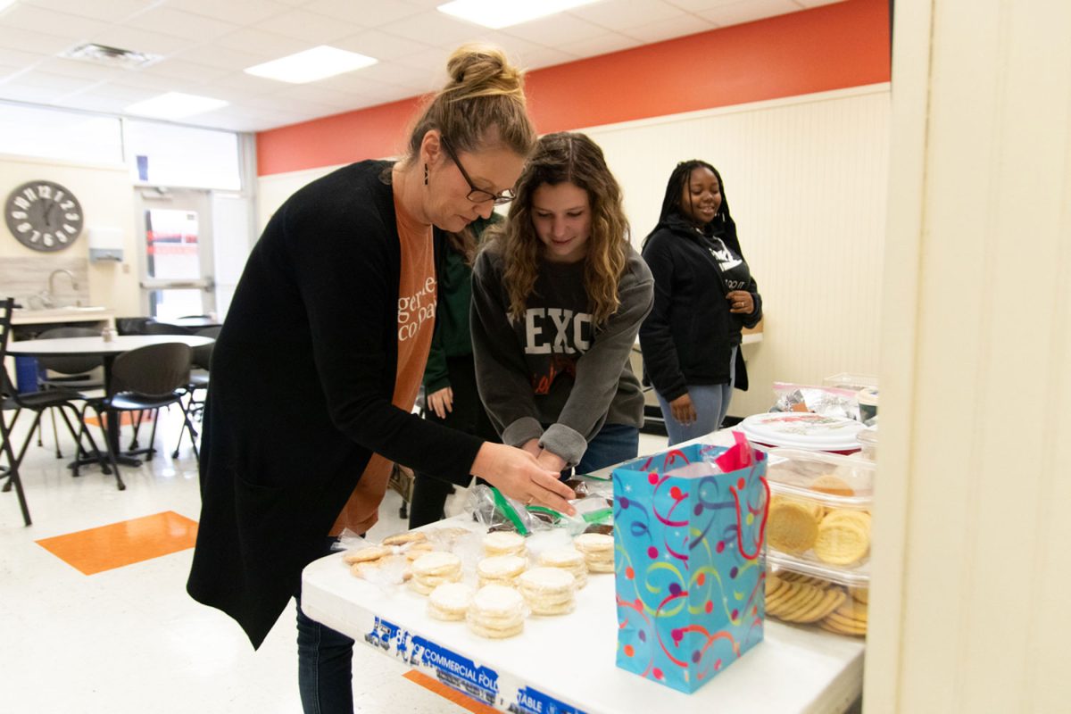 Marti Garren helps prepare snacks for the Rosebuds bake sale. Rosebuds sells baked goods annually.