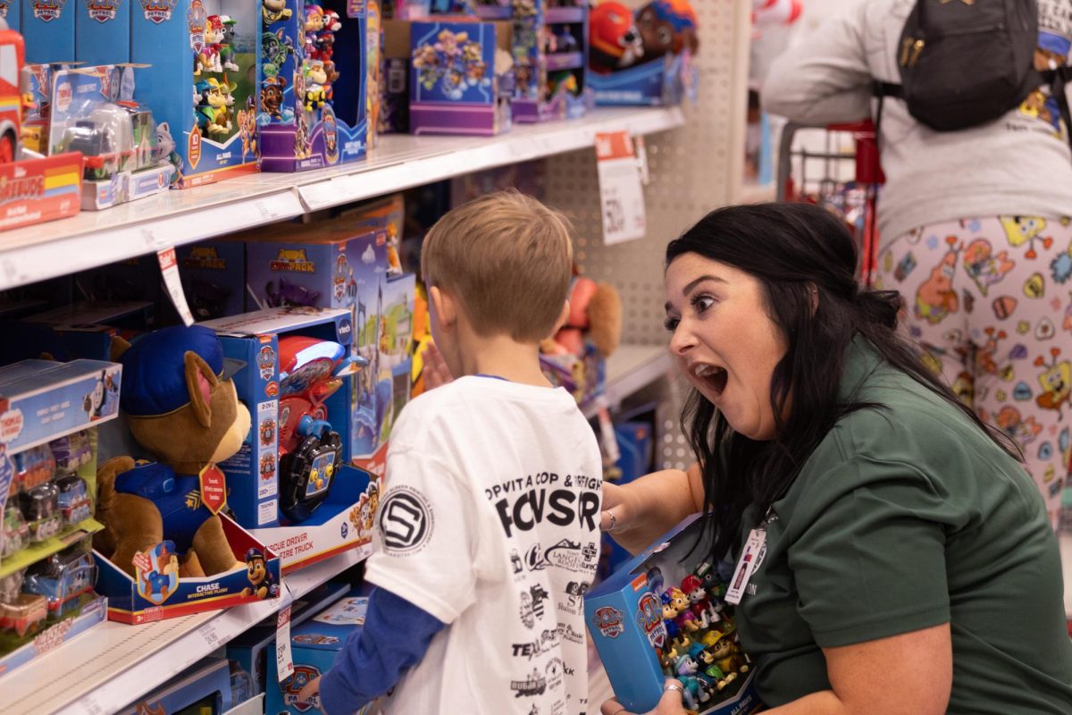 Juvenile probation officer Autumn Foster helps her shopper pick out a “Paw Patrol” toy at Target on Dec. 5. Over 130 kids shopped for their Christmas gifts with first responder. 