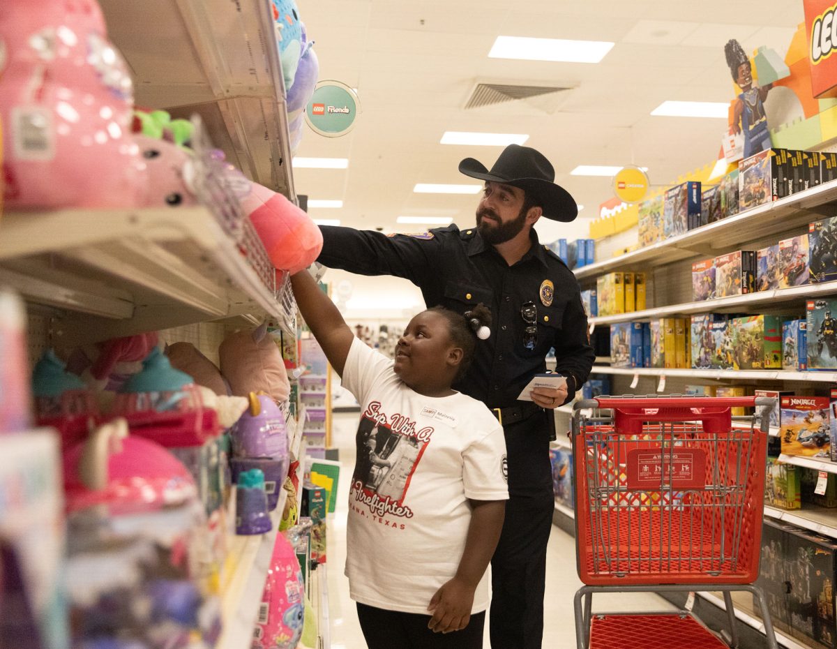 On the stuffed animal aisle, Malaysia Baker tests the texture of the toys with her officer while shopping.