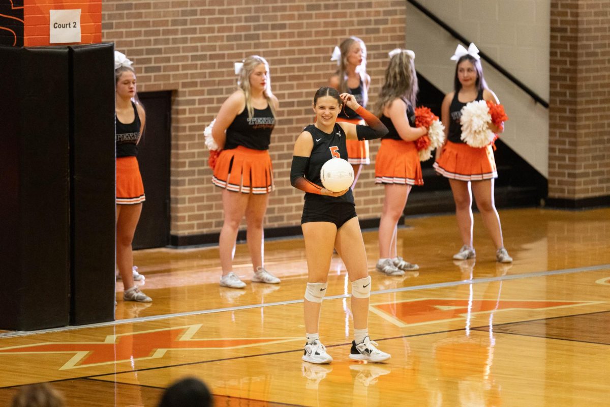 Senior Mally Lumpkin smiles as she goes to the service line in a pre-season game against Sulphur Springs Tuesday, Sept. 5, 2023. Lumpkin was selected to be recognized as the 2023-2024 volleyball Face of the Game.