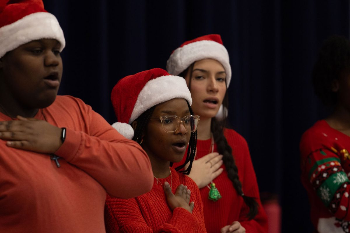 With her Christmas attire, senior Salem Alonge sings in their Christmas Caroling tour at Morris Elementary on Dec. 11, 2023. Texas High choir traveled to four schools to sing. 
