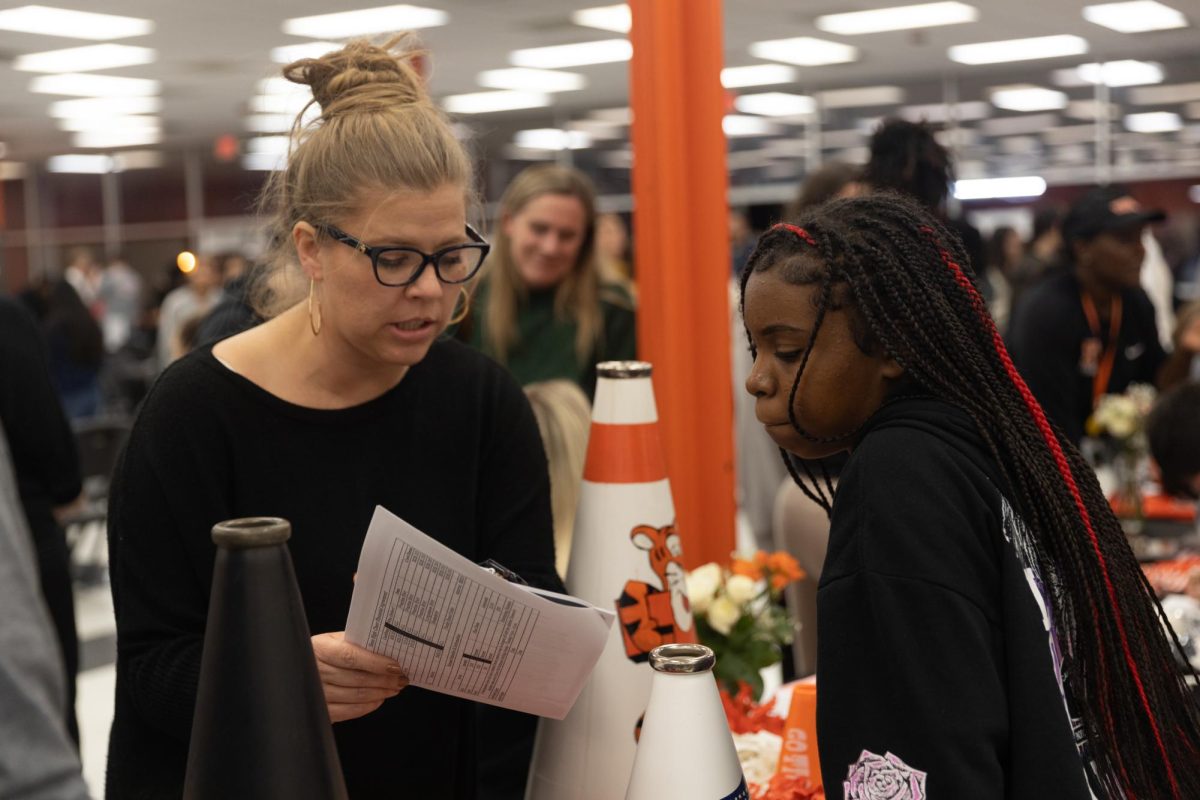 Cheer coach Courtney Waldrep visits with a prospective eighth-grader at the Experience Texas High School event. THS faculty answered questions of students and parents to help ease the transition between Texas Middle School and Texas High School. 