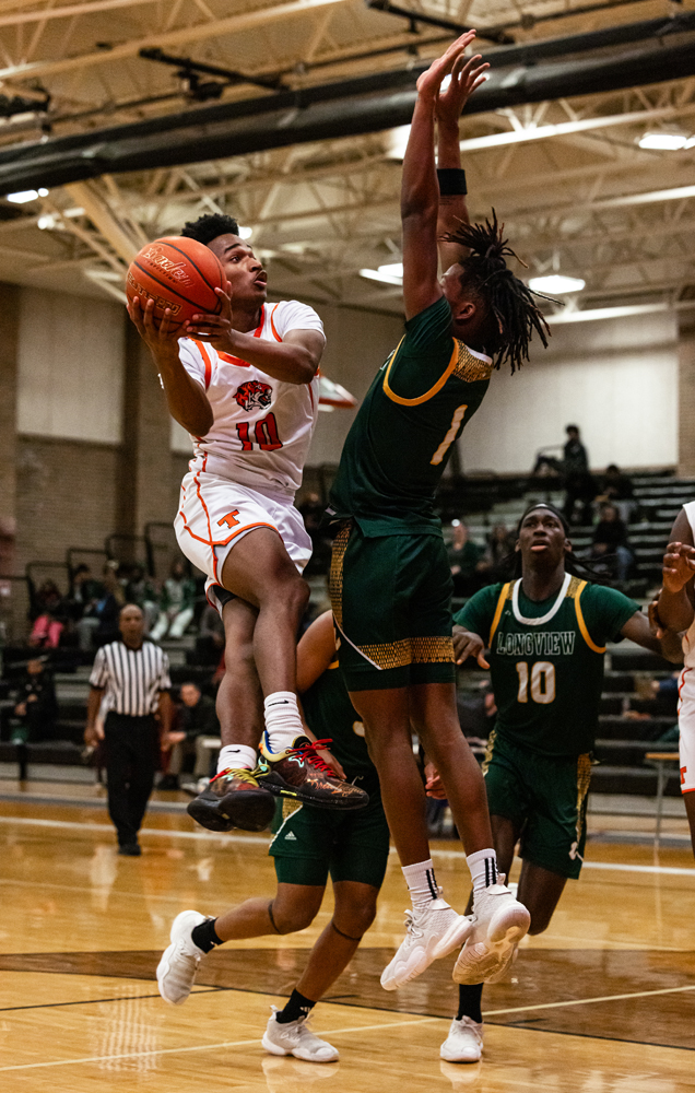 Junior Jimon Haynes goes up for a layup in a district match against the Longview Lobos Tuesday, Jan. 9, 2024. The Lobos defeated the Tigers.