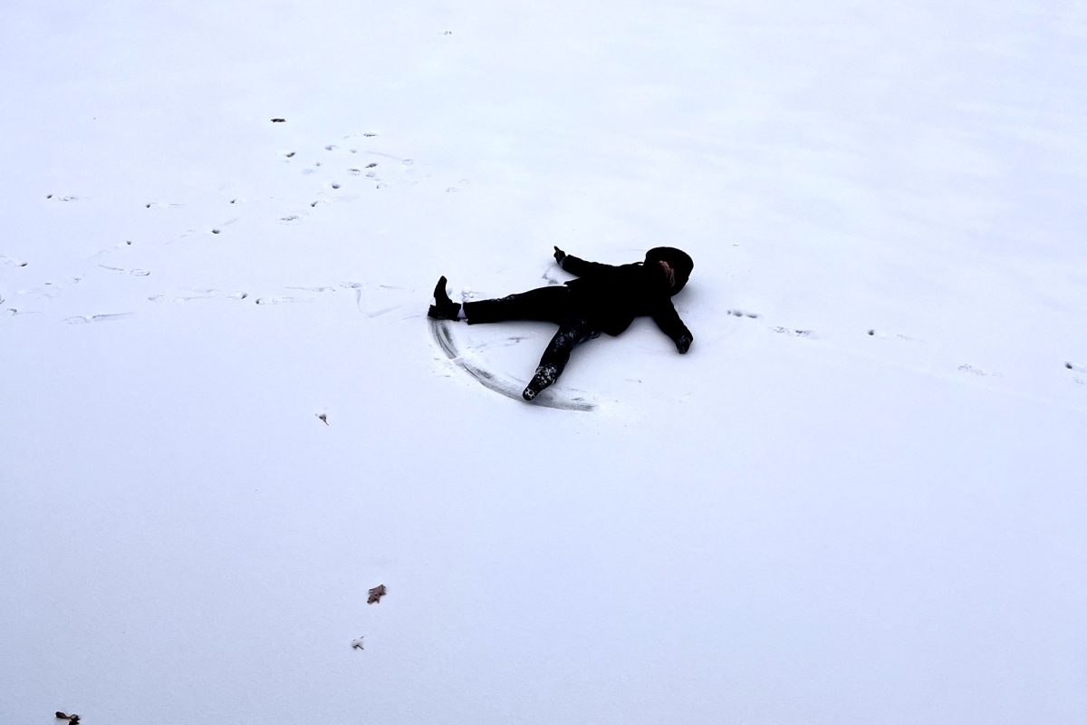 SUBMITTED PHOTO BY CARLY HICKERSON: Scratching mainly sleet and ice with her arms and feet, junior Sarah Jane Woodman attempts to create a snow angel on the tennis courts of North Ridge Country Club after the first winter storm of 2024 hit Texarkana on Jan. 14. Some Texas High School students played in the wintry weather and other worked to keep livestock and their homes safe from the below freezing temperatures.