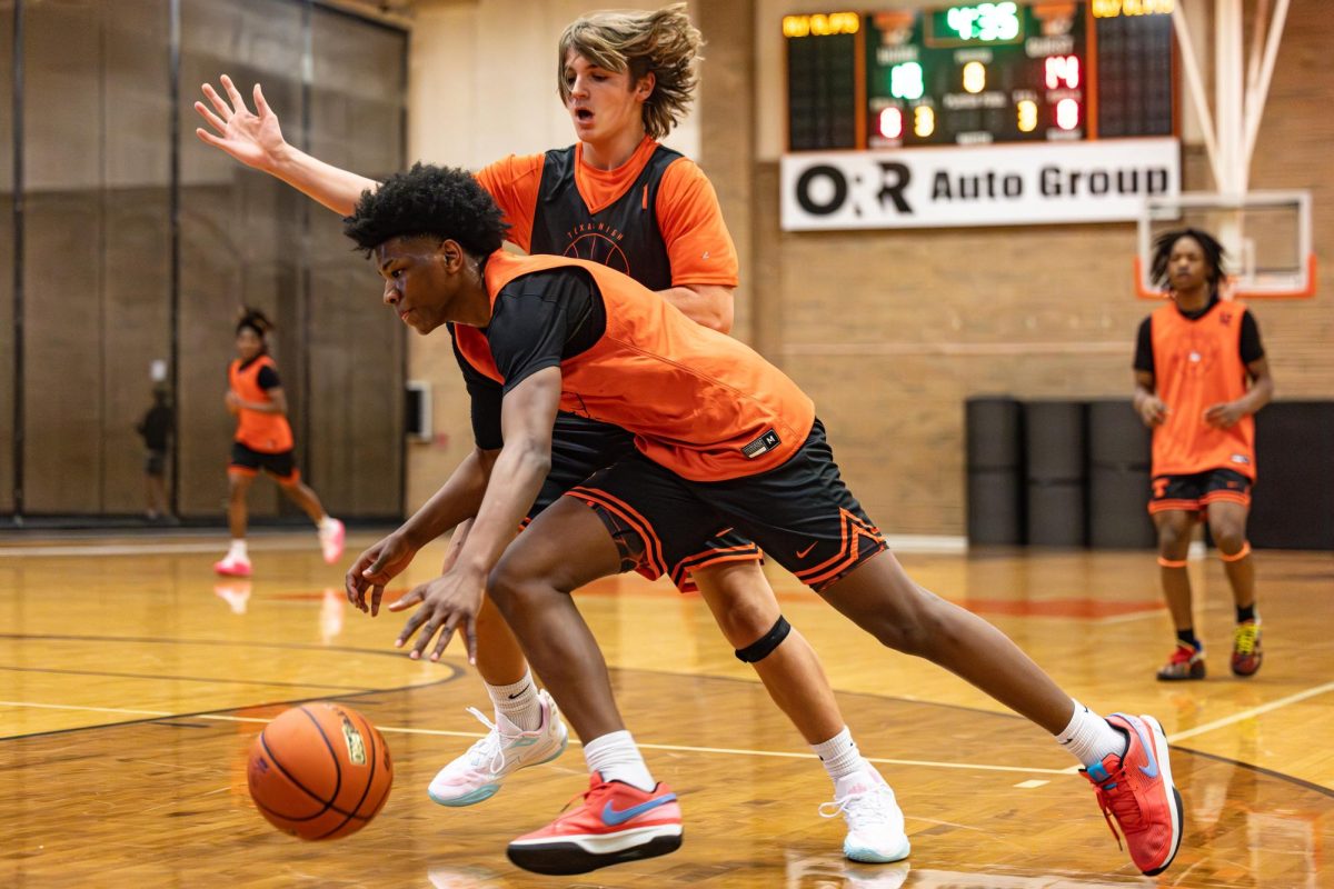 Junior+Justin+Brown+drives+the+paint+in+a+pre-season+practice+scrimmage.+Brown+was+selected+to+be+recognized+as+the+2023-2024+basketball+pre-season+Face+of+the+Game.