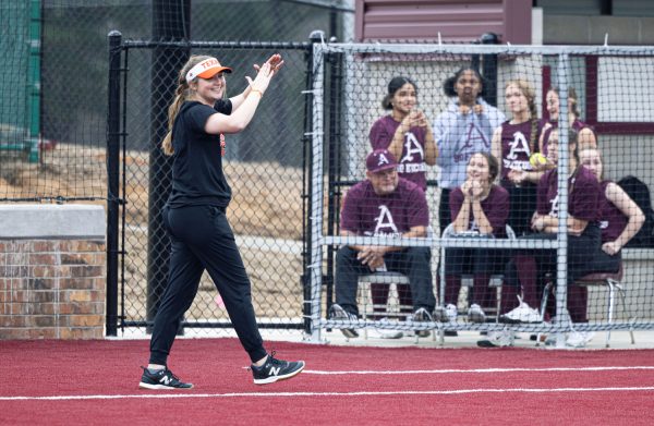 Former Texas High School softball stand out turned head coach Chealsea Slider claps after a player reaches second base. Slider became the head coach only days before the start of the 2023 UIL season.