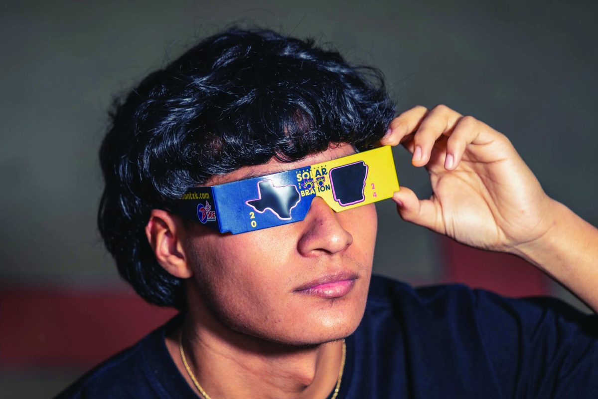 Senior Miguel Don Juan tests out Solarbration themed solar eclipse glasses in preparation for the upcoming solar eclipse on April 8. A total solar eclipse will pass through Texarkana for the first time in 375 years. 
