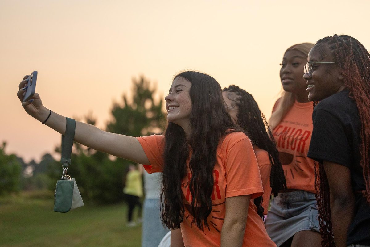 While attending the annual Senior Sunrise event, senior Kate Cook takes a selfie with friends. Senior Sunrise took place at Bringle Lake Park at 6 a.m. on Aug. 8, 2025 and served as the kick off for the 2025-2026 school year. 