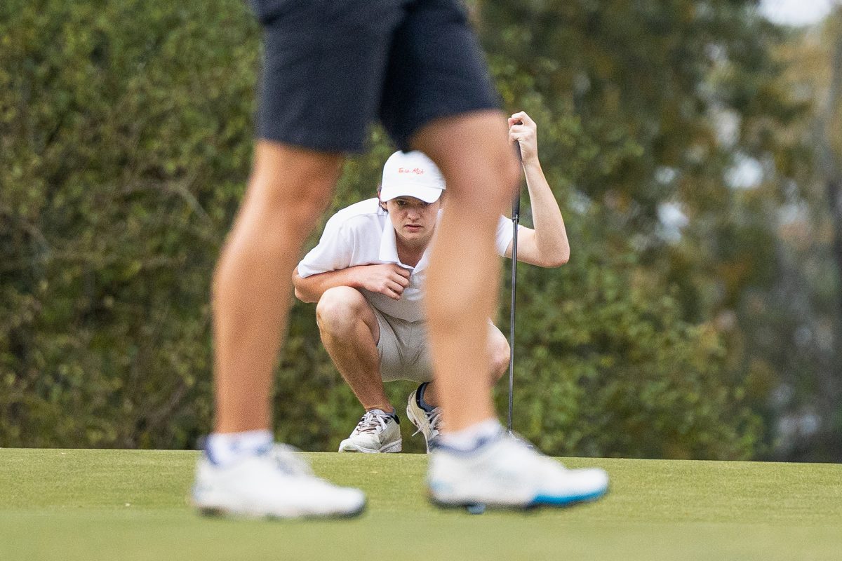 Senior David Mayo aligns his putt at the Jay Brewer Memorial Golf Tournament on Nov. 7, 2025. 