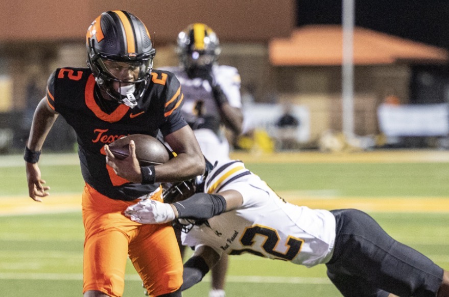 Senior quarterback Kameron Wrightner runs the ball at the Oct. 17, 2025, game against Mount Pleasant. This season, Wrightner beat the school record for the total number of passing touchdowns with 13/14 passing, 243 passing yards, seven passing touchdowns and 297 total yards.