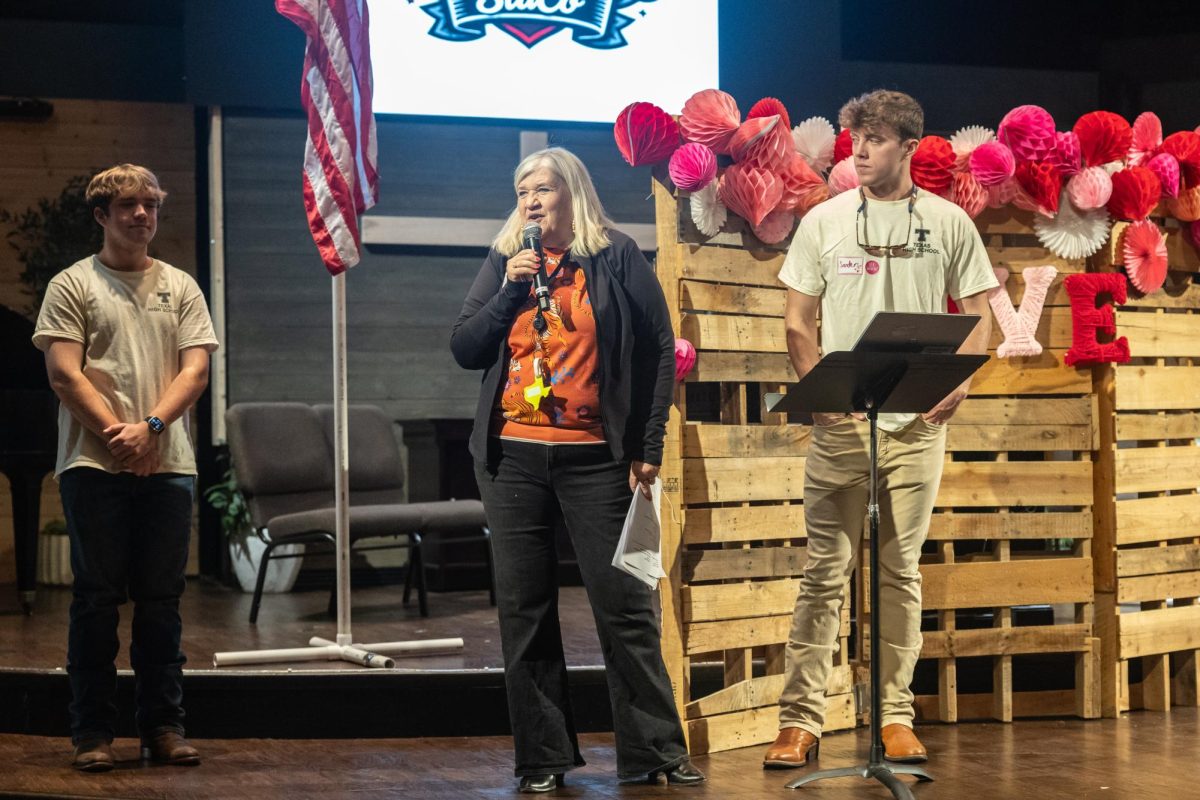 Susan Waldrep speaks into the microphone during a Student Council meeting. Waldrep holds the role of the student activities coordinator for Texas High School.