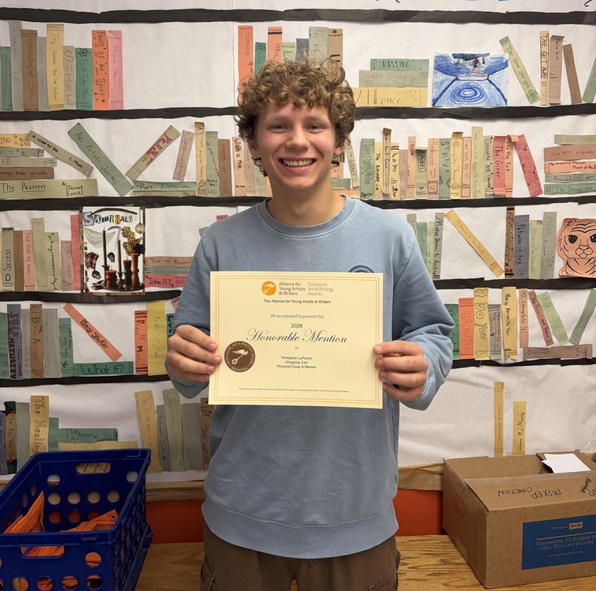 Sophomore Kristopher LaPointe smiles with his memoir award. English 2 students submitted personal essays, three of which received scholastic honors awards.