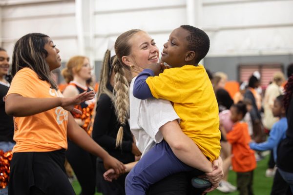 Junior Indie Fleming holds an elementary kid during the dance portion of the field day. On May 6, 2026, Texas High STUCO held its annual Tiger Strong Field Day, attended by special needs students.