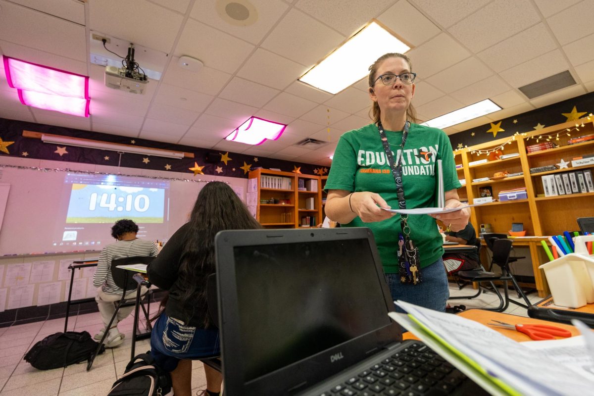 Algebra 1 teacher Alissa Bell passes assignments out to students. Bell's history teaching stretched 11 years before moving to Texas High in the fall of the 25-26 school year.