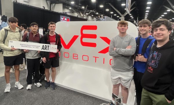 Students of the robotics team smile with their team name at the VEX Robotics sign. From Apr. 21-24 2026, Texas High School’s ‘Overworked and Underpaid’ robotics team participated in the VEX Robotics World Championships in St. Louis, Mo.